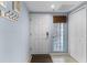 Inviting entryway featuring a solid white front door and natural light from glass block window at 5300 S Atlantic Ave # 16-202, New Smyrna Beach, FL 32169