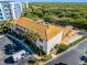 The rec building has a yellow tiled roof, lush landscaping, and parking at 5300 S Atlantic Ave # 16-202, New Smyrna Beach, FL 32169