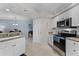 Open kitchen featuring granite countertops and stainless steel appliances, seamlessly connected to living areas at 5300 S Atlantic Ave # 16-202, New Smyrna Beach, FL 32169
