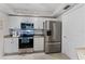 Well-equipped kitchen with stainless steel appliances, granite counters, and ample cabinet space at 5300 S Atlantic Ave # 16-202, New Smyrna Beach, FL 32169