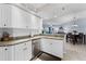 Open kitchen with white cabinetry, granite countertops, and stainless steel appliances at 5300 S Atlantic Ave # 16-202, New Smyrna Beach, FL 32169