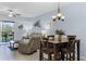Open-concept living area with tile flooring, comfortable seating, and dining space at 5300 S Atlantic Ave # 16-202, New Smyrna Beach, FL 32169