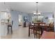 Bright, open-concept living space with a dining area and access to a private balcony at 5300 S Atlantic Ave # 16-202, New Smyrna Beach, FL 32169