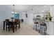 Open floor plan combining kitchen, dining, and living areas with tiled floors and neutral colors at 5300 S Atlantic Ave # 16-202, New Smyrna Beach, FL 32169