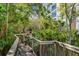 Picturesque wooden walkway winding through lush greenery, leading to the building at 5300 S Atlantic Ave # 16-202, New Smyrna Beach, FL 32169
