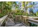 Scenic boardwalk path leading to the building surrounded by tropical foliage and trees at 5300 S Atlantic Ave # 16-202, New Smyrna Beach, FL 32169