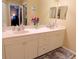 Bathroom featuring double sinks, a vanity with storage, and a mirror at 5375 Compass Pt # 04, Oxford, FL 34484