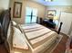 Cozy bedroom showcases wood floors, natural light and a spacious closet perfect for relaxing and unwinding at 5375 Compass Pt # 04, Oxford, FL 34484