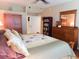 Bedroom with wooden furniture, including a bed frame, dressers, and closet space at 5375 Compass Pt # 04, Oxford, FL 34484