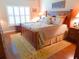 Cozy bedroom with a wooden bed frame, neutral bedding, and a window for natural light at 5375 Compass Pt # 04, Oxford, FL 34484