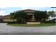 Beautiful view of the clubhouse with lush landscaping and a fountain in a well maintained planned community at 5375 Compass Pt # 04, Oxford, FL 34484