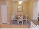 Cozy dining area with a round table, four chairs, a ceiling fan, and neutral decor at 5375 Compass Pt # 04, Oxford, FL 34484