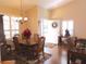 Bright dining room with wood floors, a chandelier, and plantation shutters at 5375 Compass Pt # 04, Oxford, FL 34484