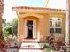 Inviting entrance with an open door, complemented by lush landscaping at 5375 Compass Pt # 04, Oxford, FL 34484