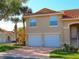 Charming townhome with a tile roof, two-car garage, and well-maintained landscaping at 5375 Compass Pt # 04, Oxford, FL 34484