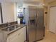 Kitchen showcasing stainless steel refrigerator, granite countertops, and ample storage space at 5375 Compass Pt # 04, Oxford, FL 34484