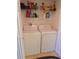 Convenient laundry room with washer, dryer and shelving for storage, adding practicality to the home at 5375 Compass Pt # 04, Oxford, FL 34484