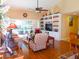 Inviting living room with hardwood floors, built-in shelving, and patio access at 5375 Compass Pt # 04, Oxford, FL 34484