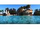 Sparkling blue pool featuring a rock waterfall and tropical landscaping, perfect for relaxing and resort-style living at 5375 Compass Pt # 04, Oxford, FL 34484