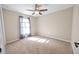 Cozy bedroom featuring neutral carpet, neutral walls, a ceiling fan, and a sunlit window at 548 E Belt Ave, Bushnell, FL 33513