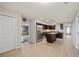 Kitchen with stainless appliances, granite countertops, an island, and wood-look tile floors at 548 E Belt Ave, Bushnell, FL 33513