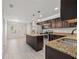 Kitchen features an island, stainless appliances, granite countertops, and opens to the dining area at 548 E Belt Ave, Bushnell, FL 33513