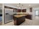 Kitchen with dark cabinets, stainless appliances, granite countertops, and a kitchen island at 548 E Belt Ave, Bushnell, FL 33513