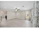 Bright living room featuring wood-look tile flooring, neutral walls, a ceiling fan and lots of natural light at 548 E Belt Ave, Bushnell, FL 33513