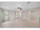 Bright living room featuring wood-look tile flooring, neutral walls, a ceiling fan and lots of natural light at 548 E Belt Ave, Bushnell, FL 33513