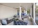 Cozy screened porch featuring comfortable seating, a table, and stylish décor perfect for outdoor relaxation at 548 E Belt Ave, Bushnell, FL 33513