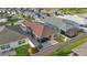 Aerial view of the backyard of home with outdoor patio, screened-in lanai, and perimeter fence at 5702 Grimes Ct, The Villages, FL 32163