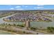 A stunning aerial view showcases a residential community surrounding two pristine lakes at 5702 Grimes Ct, The Villages, FL 32163