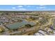 A picturesque aerial view showcases a residential community nestled around a scenic lake at 5702 Grimes Ct, The Villages, FL 32163