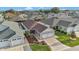 Aerial view of the charming single-story home with well-maintained landscaping and an attached two-car garage at 5702 Grimes Ct, The Villages, FL 32163