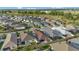 Aerial view of a residential area including lawns, landscaping, and home exteriors at 5702 Grimes Ct, The Villages, FL 32163