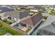 Overhead shot showcases the home's backyard and adjacent yard areas surrounded by lush green spaces at 5702 Grimes Ct, The Villages, FL 32163