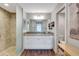 Bathroom featuring granite countertops, a glass enclosed shower, and white cabinets at 5702 Grimes Ct, The Villages, FL 32163