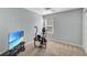 Guest bedroom featuring a ceiling fan, large window, and tv at 5702 Grimes Ct, The Villages, FL 32163