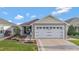Charming single Gathering home featuring a two-car garage, inviting front patio, and lovely landscaping at 5702 Grimes Ct, The Villages, FL 32163