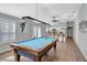 Comfortable game room with a pool table, ceiling fan, and views into the kitchen at 5702 Grimes Ct, The Villages, FL 32163