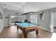 Spacious game room features a Diamond pool table, with natural light at 5702 Grimes Ct, The Villages, FL 32163