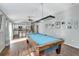 Open concept game room and kitchen with view of the living area with barstool seating at 5702 Grimes Ct, The Villages, FL 32163