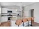 Kitchen featuring a granite island with seating, stainless steel appliances and white cabinetry at 5702 Grimes Ct, The Villages, FL 32163