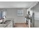 Kitchen featuring stainless steel appliances, granite countertops, and a window with plantation shutters at 5702 Grimes Ct, The Villages, FL 32163