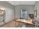 Bright office space features a ceiling fan, large window, and lots of storage at 5702 Grimes Ct, The Villages, FL 32163