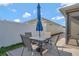 Outdoor patio features a dining table with umbrella, perfect for entertaining outdoors at 5702 Grimes Ct, The Villages, FL 32163