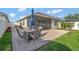 Back patio with screened-in lanai area, outdoor table and chairs at 5702 Grimes Ct, The Villages, FL 32163
