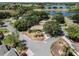 Aerial view of home in a neighborhood near a lake with mature trees, property lines included at 5906 Prince Philip Ct, Leesburg, FL 34748