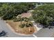 Aerial view of a home with a well-manicured lawn and landscaping near a lake at 5906 Prince Philip Ct, Leesburg, FL 34748