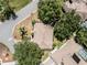 Aerial perspective of home with a tidy roof and manicured yard, near lush trees and a serene neighborhood street at 5906 Prince Philip Ct, Leesburg, FL 34748